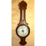 An early 20th century carved oak aneroid barometer, H. 80cm.
