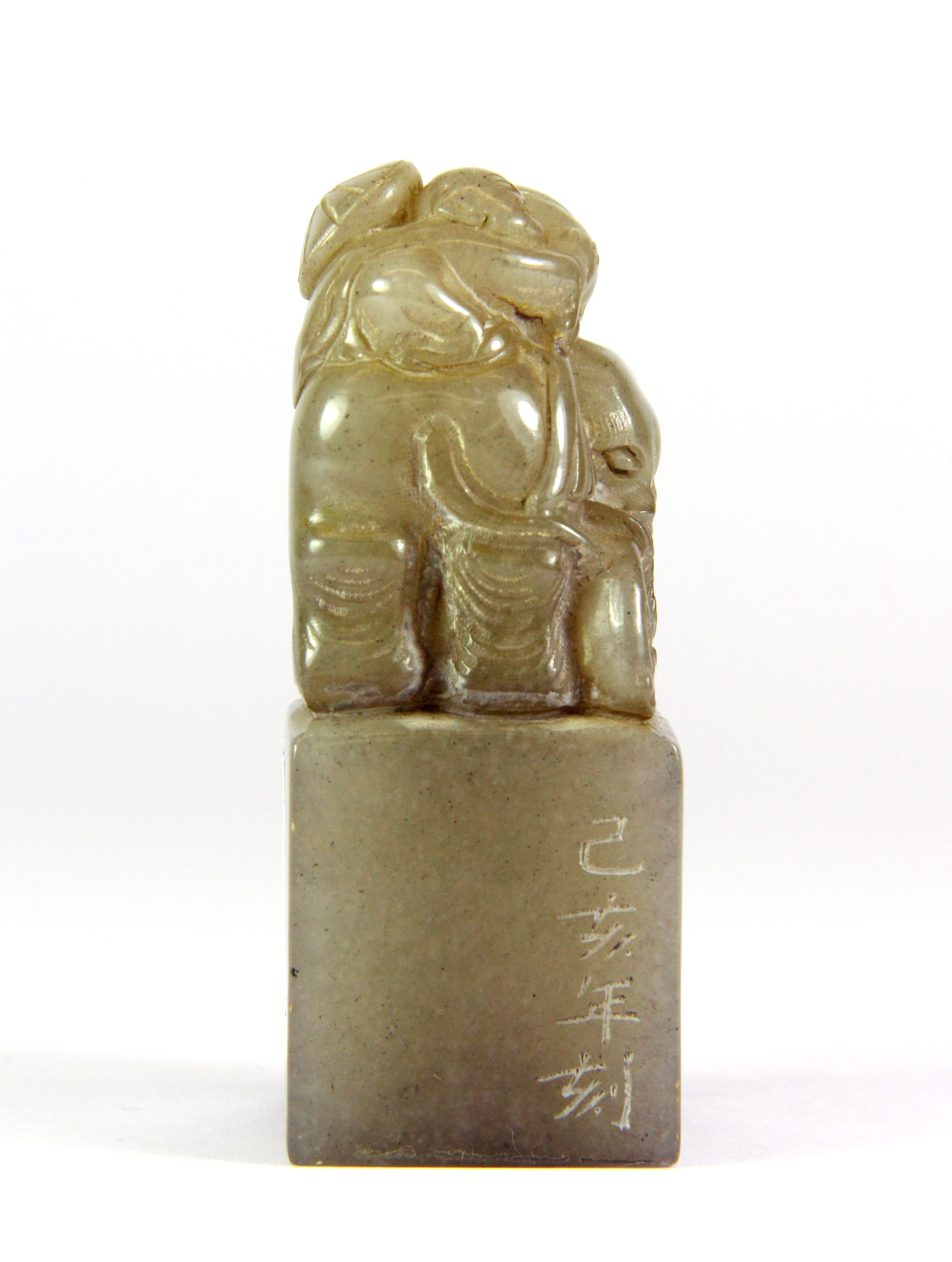 A mid 20th century Chinese carved grey soapstone seal mounted with a boy on an elephant, H. 8cm. - Image 4 of 5