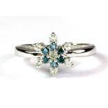 A 9ct white gold snow flake shaped ring set with blue and white diamonds, (M).