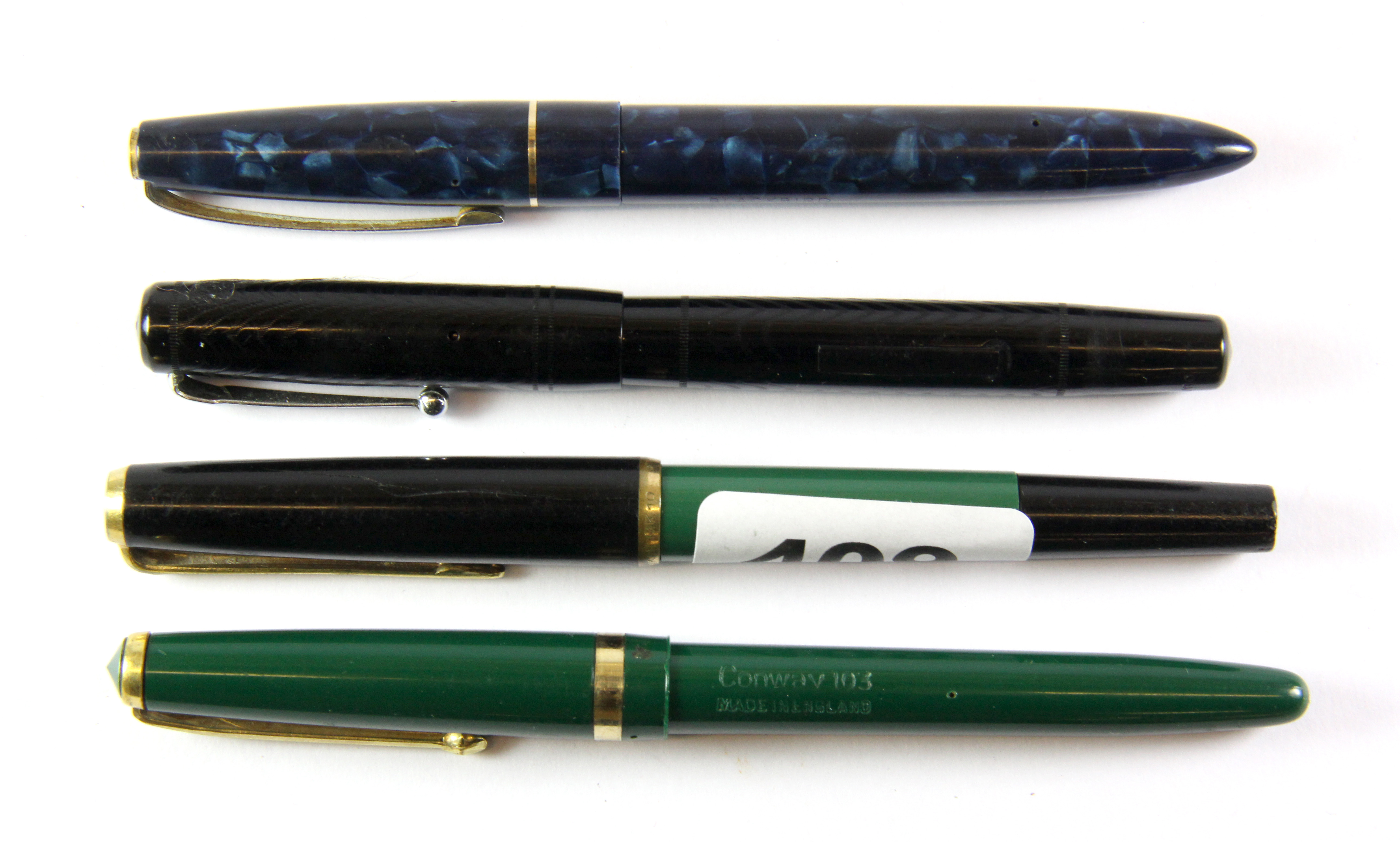 Four vintage fountain pens, all with gold nibs.