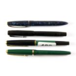 Four vintage fountain pens, all with gold nibs.