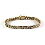 A 9ct yellow gold diamond set bracelet.