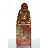 A mid 20th century Chinese carved soapstone seal mounted with a Buddhist Lohan, H. 14.5cm.