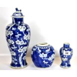 A 19th century Chinese porcelain vase and lid hand painted in the prunus pattern, H. 32cm, with four