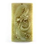 An impressive Chinese carved jade / hardstone amulet featuring a relief image of a dragons head with