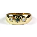 A gentleman's 9ct yellow gold gypsy ring set with a fancy blue greenish diamond flanked by two white