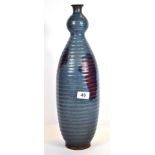 An impressive Chinese Zhun glazed pottery vase with ribbed detail and narrowed neck, H. 46cm.