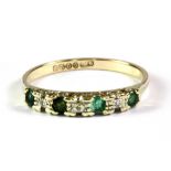 A 9ct yellow gold emerald and diamond set half eternity ring, (O).