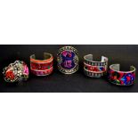 Five Chinese white metal and minority culture embroidered bangles.