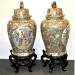A pair of large mid 20th century Chinese famille rose enamelled and gilt porcelain jars and lids
