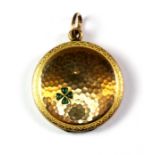 A yellow metal (tested minimum 9ct gold) portrait locket, decorated with a stone set shamrock,