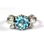 An 18ct white gold ring set with a 3.2ct natural blue zircon and baguette cut diamond set shoulders,