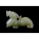 A small Chinese pale celadon nephrite jade figure of a dragon L. 7cm.