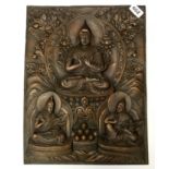 A Tibetan hammered copper panel featuring three Lamas, 33 x 42cm
