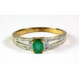 A 9ct yellow gold emerald and diamond set ring, (O.5).