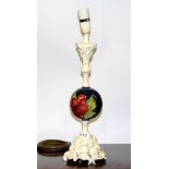 A interesting early carved wooden and Moorcroft pottery table lamp, H. 48cm.