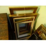 A collection of seven gilt and composite figure frames, various sizes.