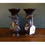 A pair of Japanese bronze baluster spill vases, each having applied relief dragon decoration,