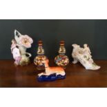 A porcelain Staffordshire pen holder, fashioned as a recumbent greyhound,