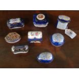 A collection of eight porcelain and enamel trinket boxes, some with hand painted decoration,