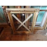 A gilt composite and moulded picture frame (80cm x 64cm).