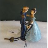 An early to mid 20th century clockwork tin plate dancing couple, with original key.