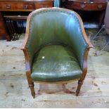 A leatherette upholstered and oak framed tub chair on turned front supports (58cm wide).