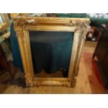 A gilt composite picture frame with moulded decoration (103cm x 82cm).