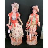 A pair of 20th century Continental bisque figurines (49cm).