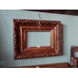 A gilt composite picture frame, having profuse moulded decoration (45cm x 57cm).