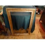 A gilt composite picture frame with moulded decoration (90cm x 67cm).