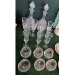 A pair of cut glass decanters, together with a set of six champagne flutes,