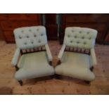 A pair of Victorian green upholstered button back armchairs on turned front supports (62cm wide).