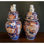 A pair of 20th century Imari baluster jars and covers, having Dog of Fo finial (35cm).