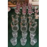 A harlequin set of nine cranberry and cut glass wine glasses, each having bird and leaf decoration,