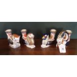 Four Royal Crown Derby Mythical Beasts candlesticks, each decorated in the Imari palette.