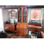 An early 20th century mahogany and inlaid bureau bookcase, the domed top over twin glazed doors,