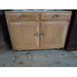 A contemporary narrow Ercol sideboard, having two drawers over two cupboard doors, (92cm wide).