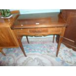 An Edwardian mahogany and inlaid fold-out games table,