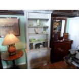 A reproduction blue painted cupboard bookshelf, (97cm wide).