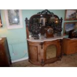 A Victorian mirror backed walnut chiffonier, having scroll and leaf pediment over shaped marble top,