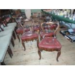 A set of six Victorian rosewood scrolled bar back dining chairs,