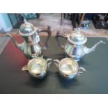 A matched four piece silver coffee set, comprising: coffee pot, hot water pot,