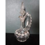 A Victorian painted glass decanter and stopper, having a frilled loop handle,