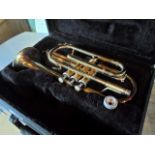 A cased brass 300 series trumpet by E. L. Rharl.