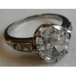 A single stone diamond ring, the old oval shallow cut stone in simple claw mount,