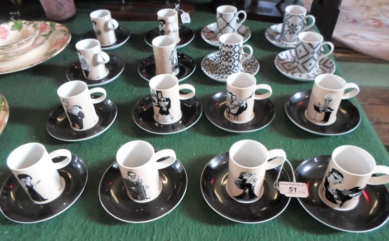 A collection of contemporary Vista Alegre coffee cans and saucers, various designs.