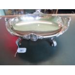 A Regency-style oval silver dish on four scroll supports, Roberts & Belk, Sheffield 1937.