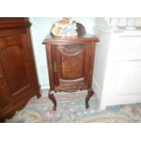 A late Victorian mahogany and walnut single door pot cupboard on cabriole supports, (43cm wide).