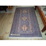 An Eastern-style carpet, central fields with repeating geometric design within a mushroom border,